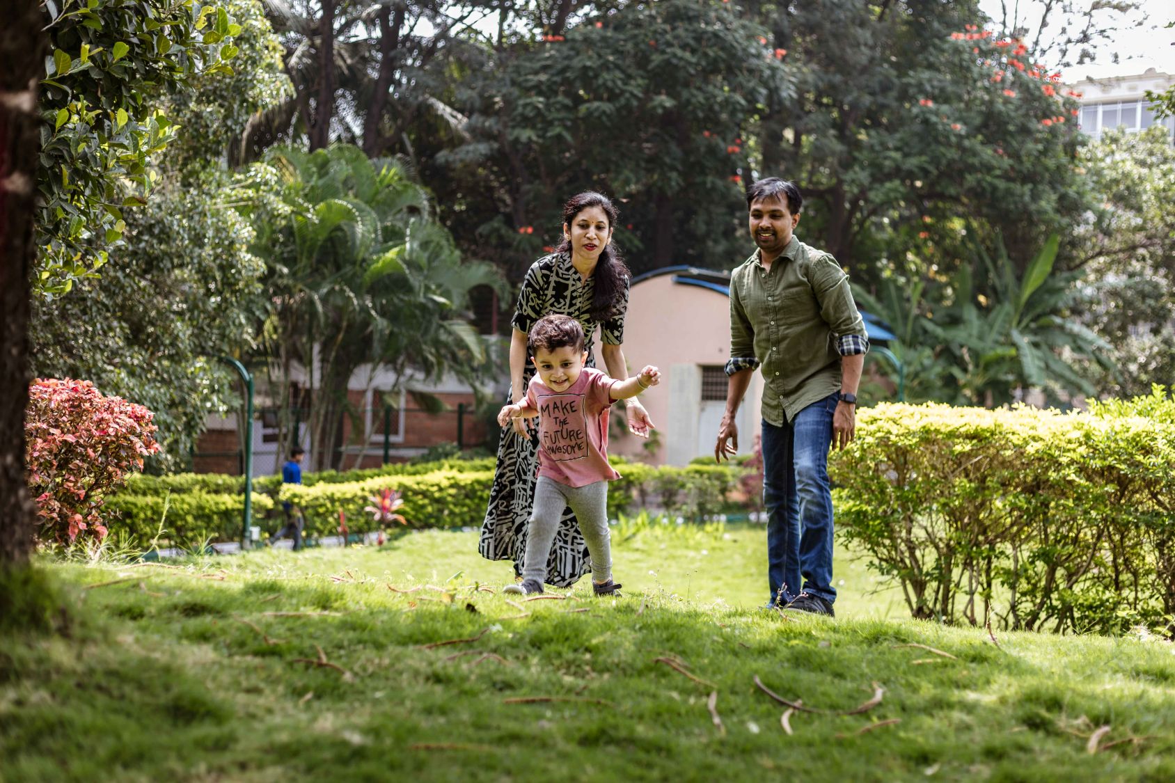 parents looking cute son running grassy land park low